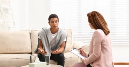 therapist talking to young man